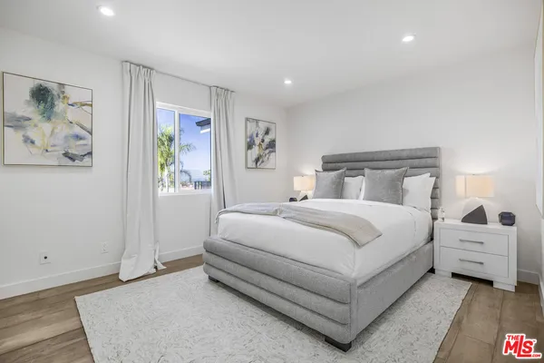 a bedroom with a large bed and a window
