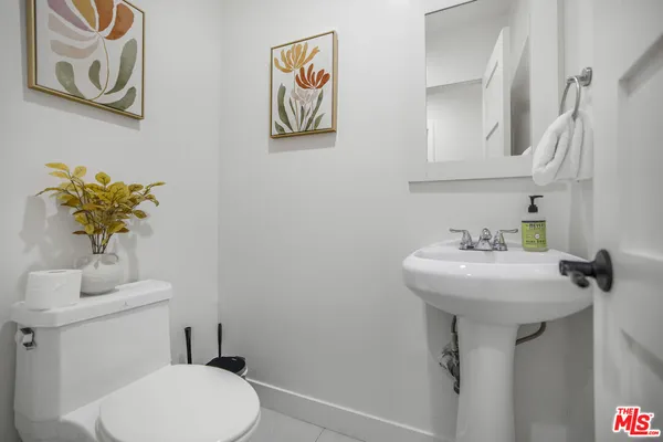 a bathroom with a sink mirror and toilet
