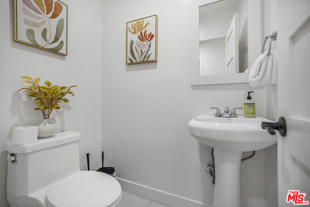 18202 Rancho Street Tarzana, CA 91356 - Photo 33 of 33 a bathroom with a sink mirror and toilet