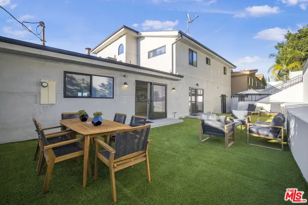 a view of a house with backyard sitting area