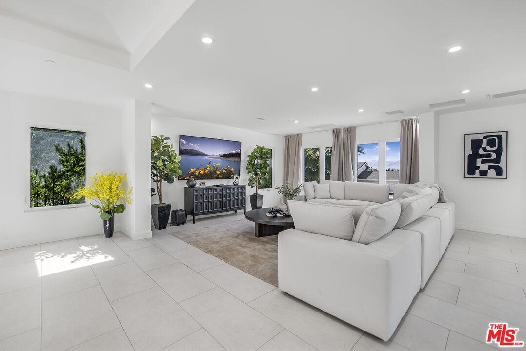 18202 Rancho Street Tarzana, CA 91356 - Photo 5 of 33 a living room with furniture and a flat screen tv