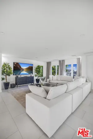 a living room with fireplace furniture and a potted plant