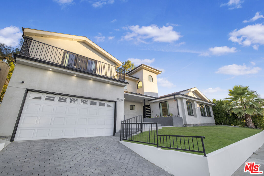 18202 Rancho Street Tarzana, CA 91356 - Photo 7 of 33 front view of a house with a yard