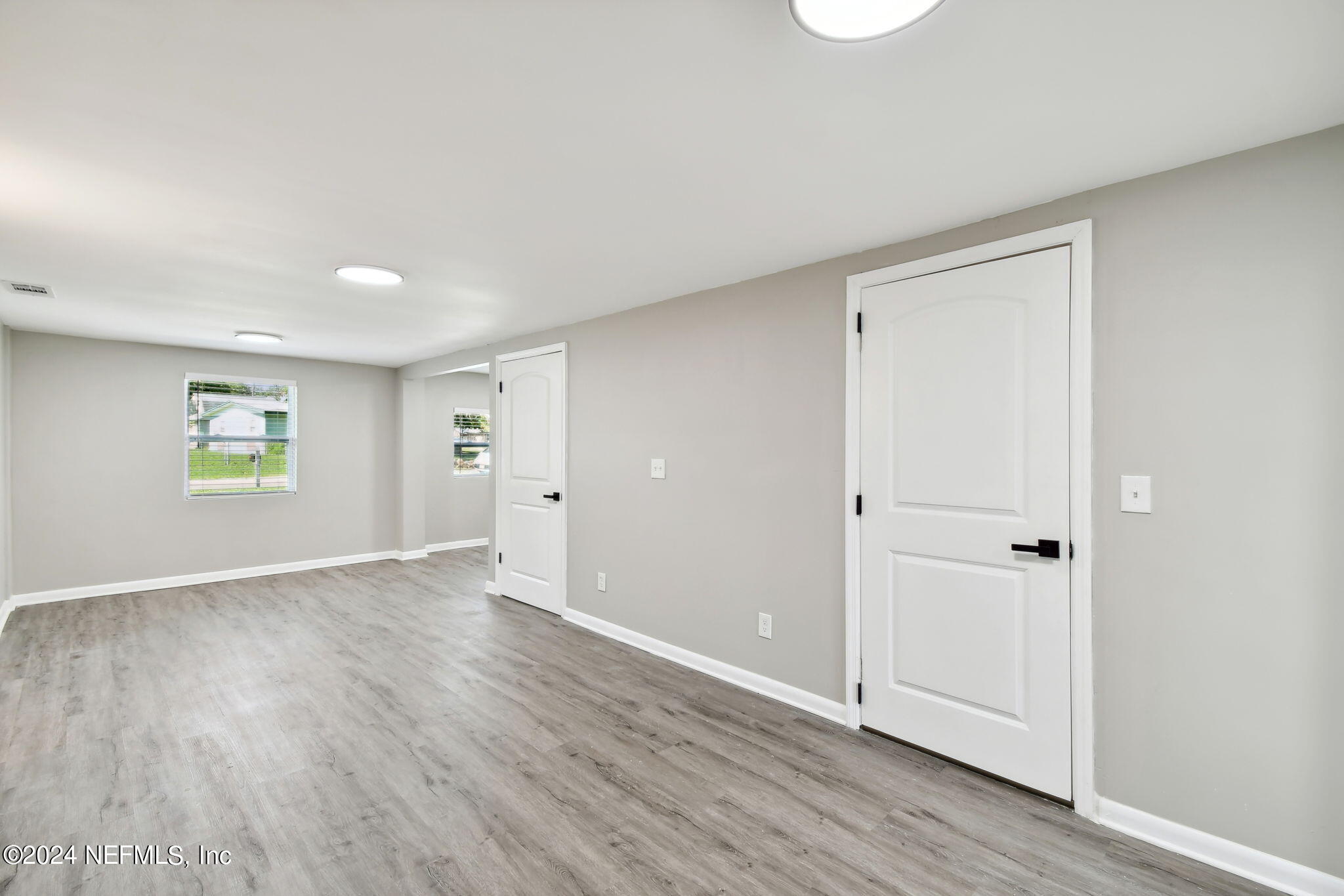 7518 Pinnacle Drive Jacksonville, FL 32221 - Photo 11 of 28 an empty room with wooden floor and windows