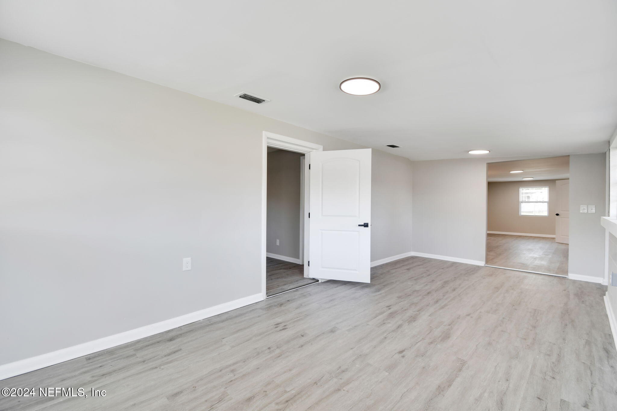 7518 Pinnacle Drive Jacksonville, FL 32221 - Photo 14 of 28 a view of empty room with wooden floor and window