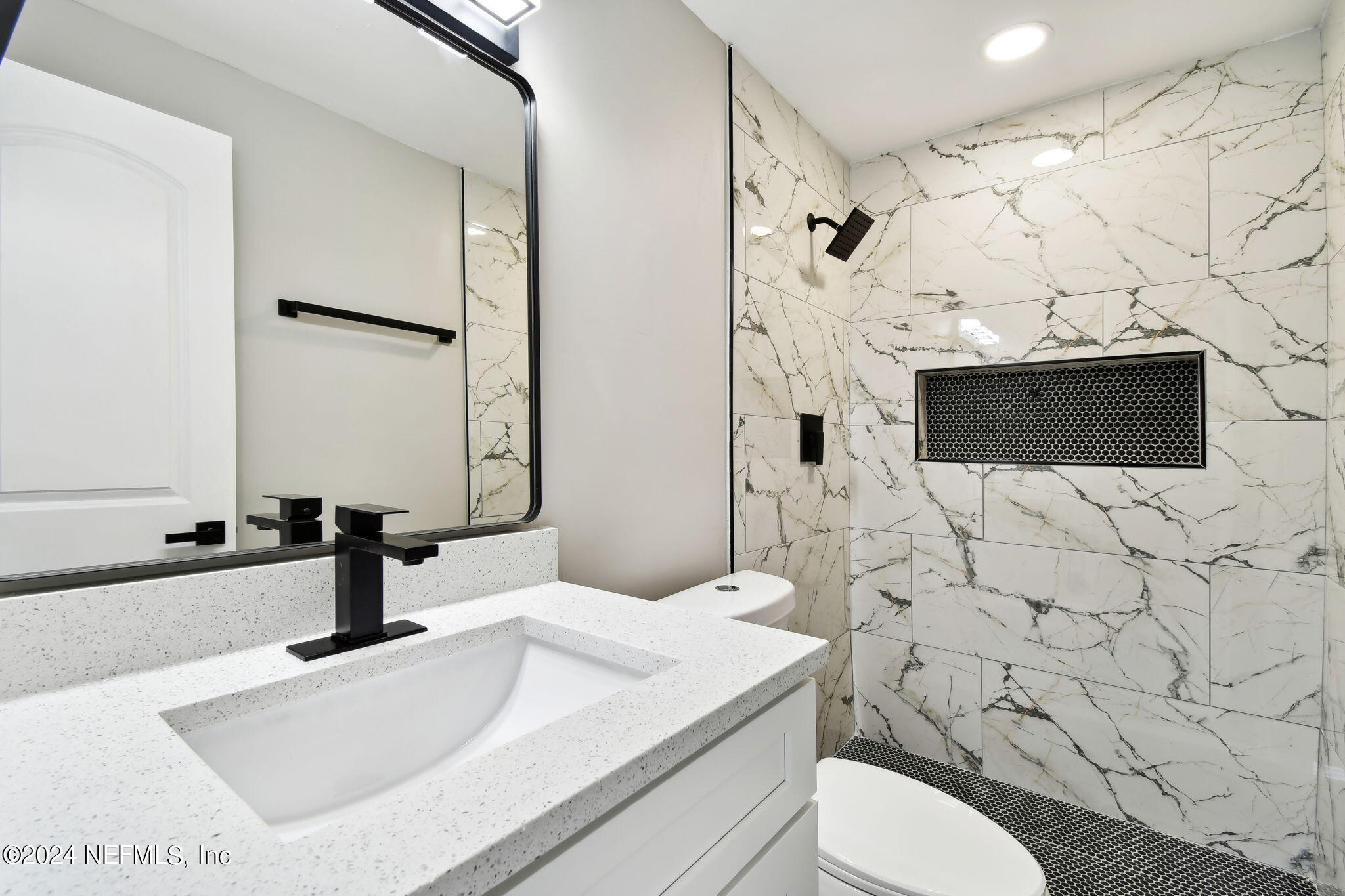 7518 Pinnacle Drive Jacksonville, FL 32221 - Photo 17 of 28 a bathroom with a sink toilet and shower