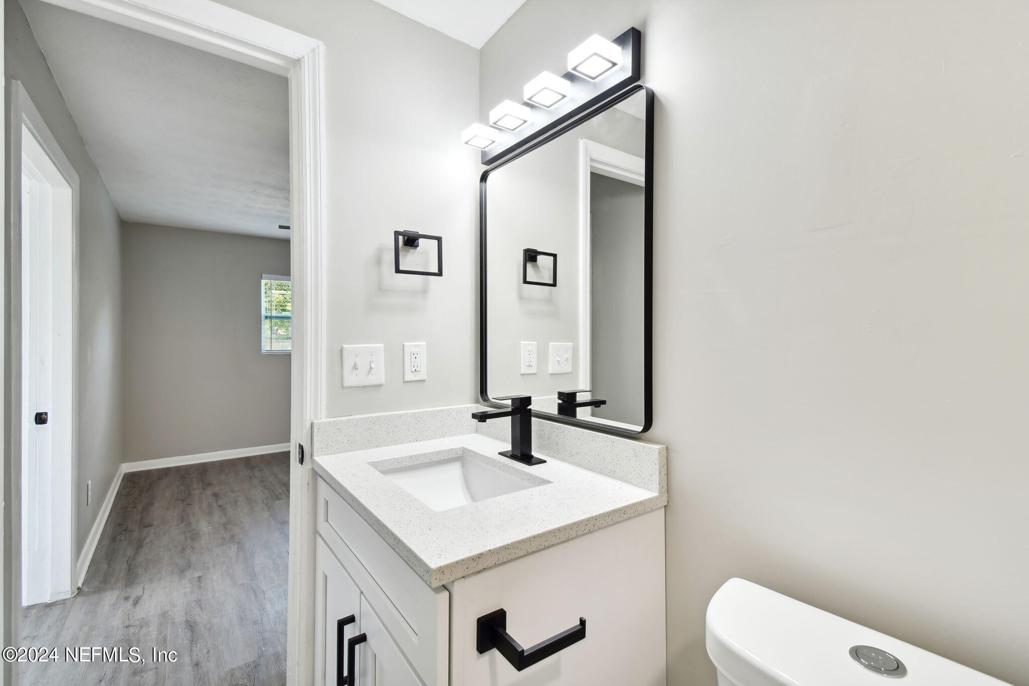 7518 Pinnacle Drive Jacksonville, FL 32221 - Photo 18 of 28 a bathroom with a sink and a mirror
