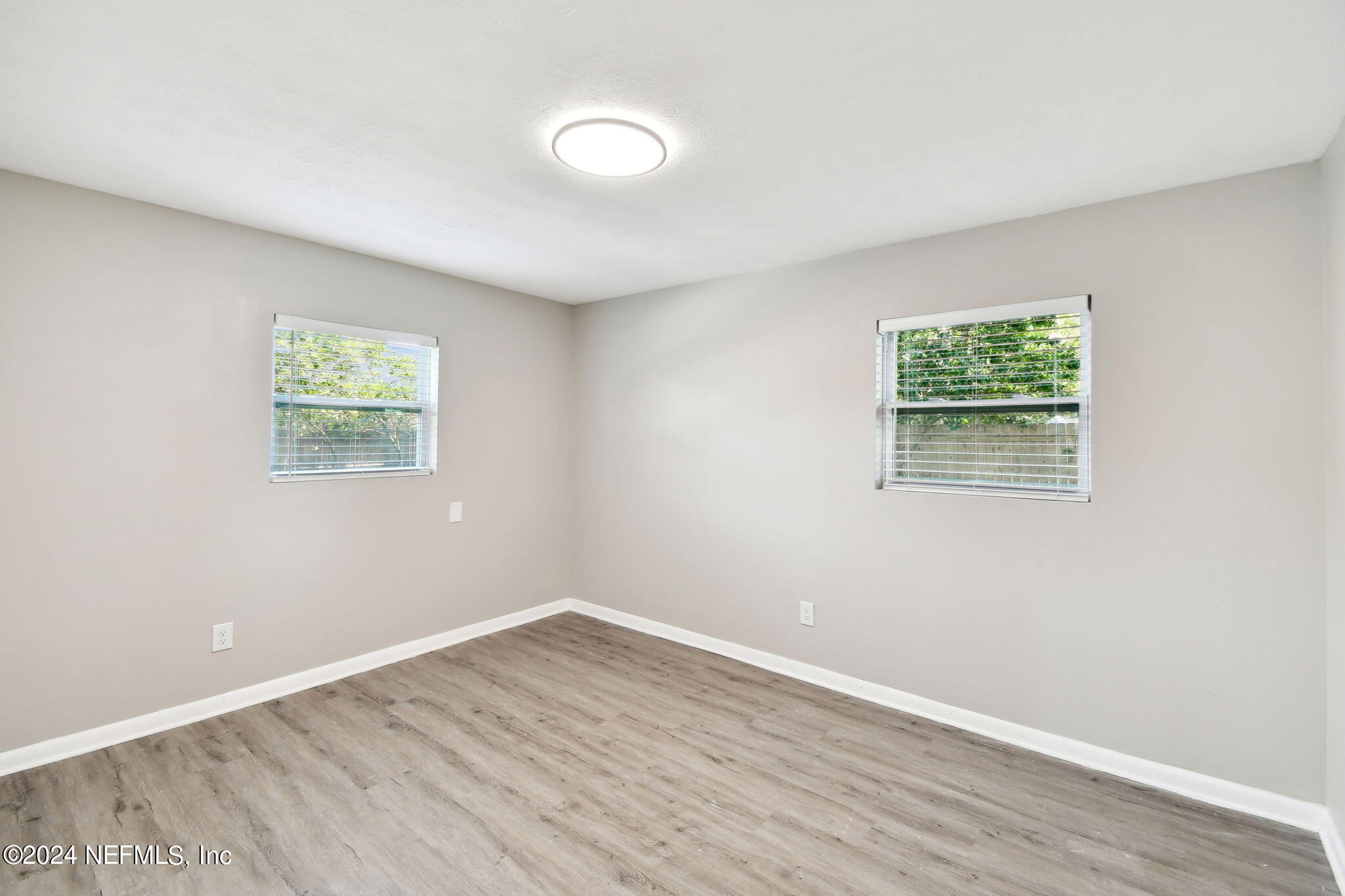 7518 Pinnacle Drive Jacksonville, FL 32221 - Photo 19 of 28 wooden floor in an empty room with a window