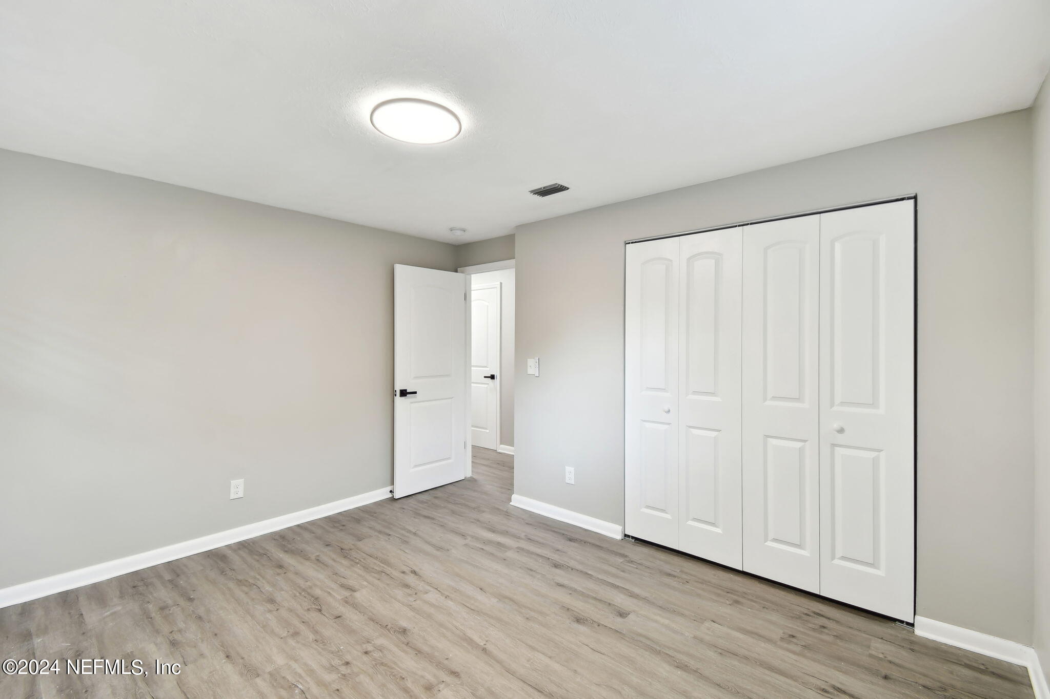 7518 Pinnacle Drive Jacksonville, FL 32221 - Photo 20 of 28 a view of an empty room with wooden floor
