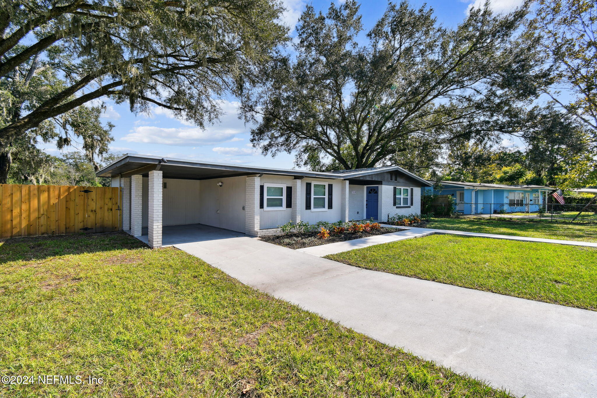 7518 Pinnacle Drive Jacksonville, FL 32221 - Photo 2 of 28 a front view of a house with a yard and garage