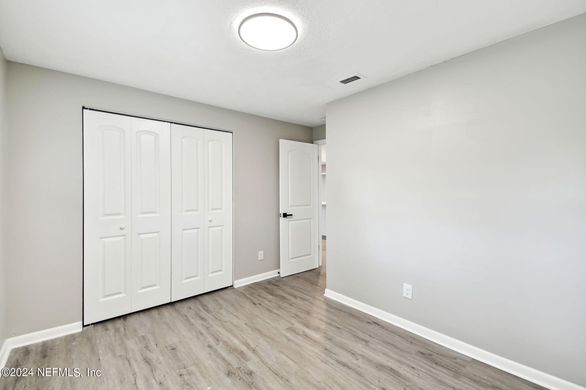 7518 Pinnacle Drive Jacksonville, FL 32221 - Photo 24 of 28 a view of an empty room with wooden floor