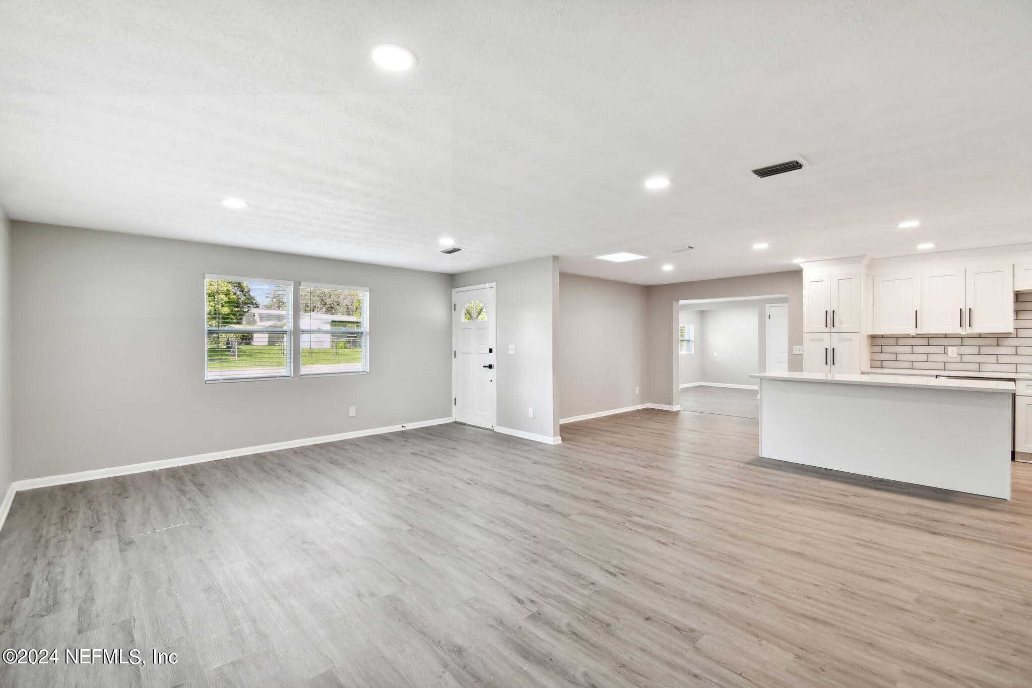 7518 Pinnacle Drive Jacksonville, FL 32221 - Photo 5 of 28 a view of an empty room with a window and wooden floor