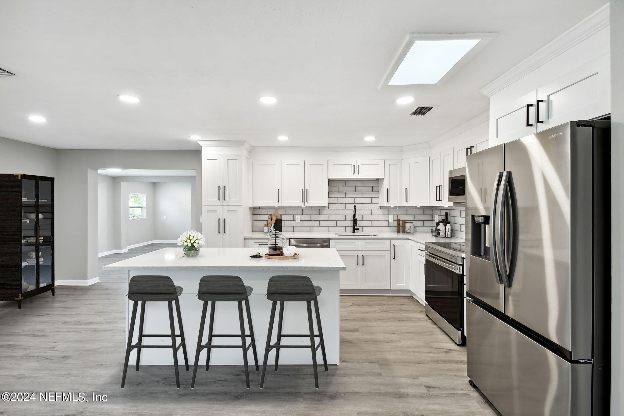 7518 Pinnacle Drive Jacksonville, FL 32221 - Photo 8 of 28 a kitchen with stainless steel appliances a refrigerator a stove a sink a dining table and chairs