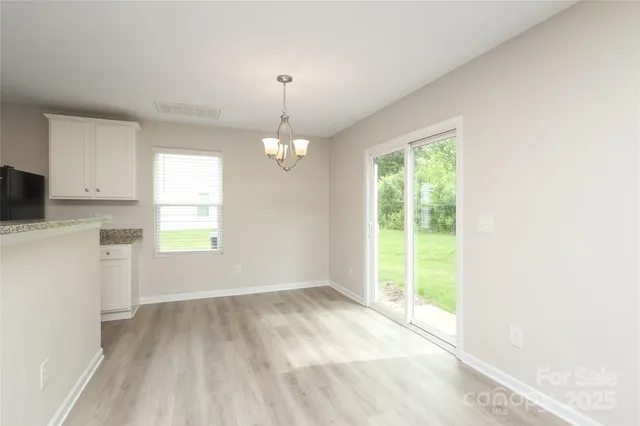 a kitchen with stainless steel appliances granite countertop a refrigerator a stove a sink and a microwave