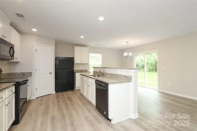 a bathroom with a granite countertop sink a mirror and a vanity