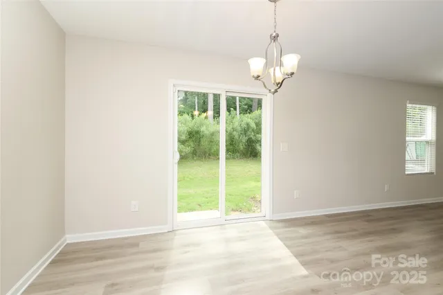 a kitchen with a refrigerator a stove top oven and a sink
