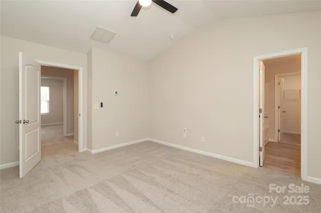 an empty room with a empty space and a ceiling fan