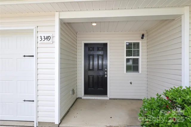 a view of front door and a yard