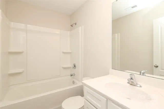 a bathroom with a walk in closet and shower