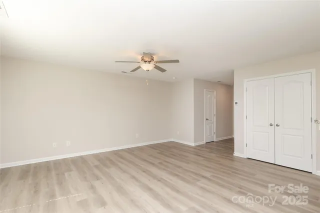 a view of a kitchen with a sink and a refrigerator