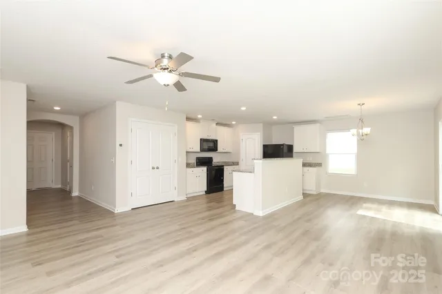 a view of a kitchen with a sink a refrigerator and a fireplace