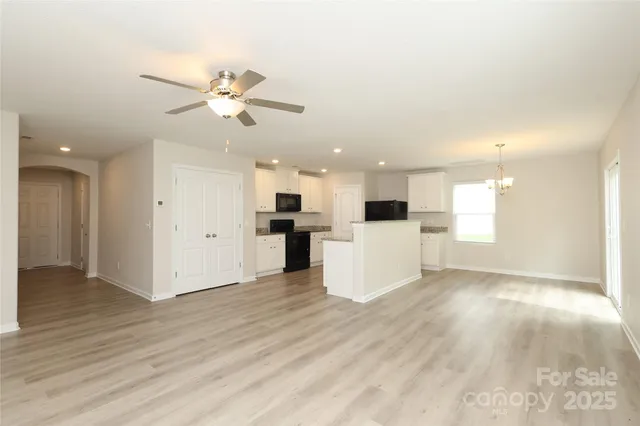a kitchen with a refrigerator a stove top oven a sink and cabinets
