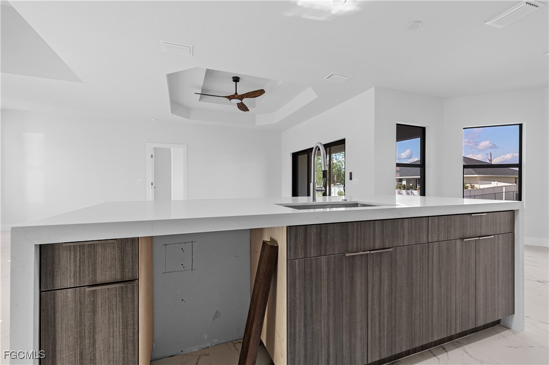 3728 9th Street West Lehigh Acres, FL 33971 - Photo 11 of 35 a kitchen with a sink and wooden floor