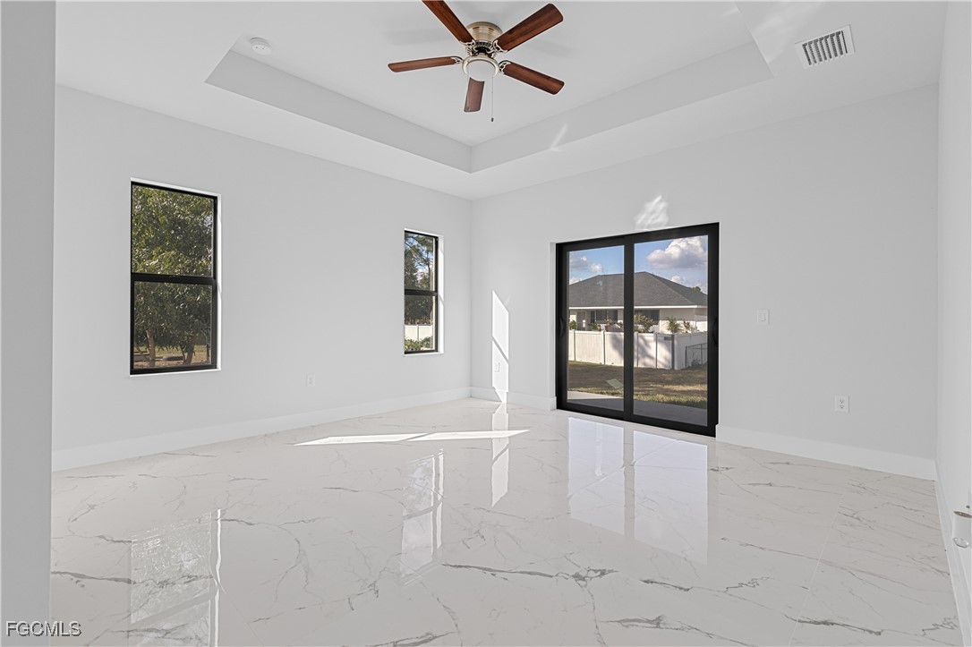 3728 9th Street West Lehigh Acres, FL 33971 - Photo 16 of 35 a view of an empty room with a window and a ceiling fan