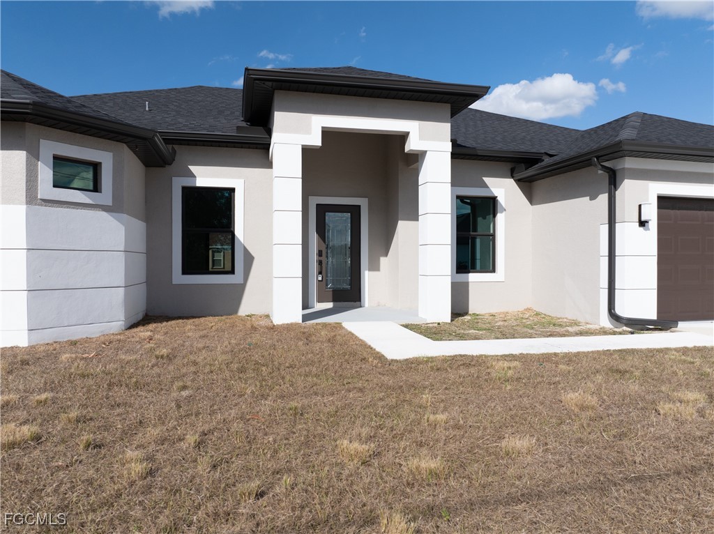 3728 9th Street West Lehigh Acres, FL 33971 - Photo 2 of 35 a view of a house with a patio
