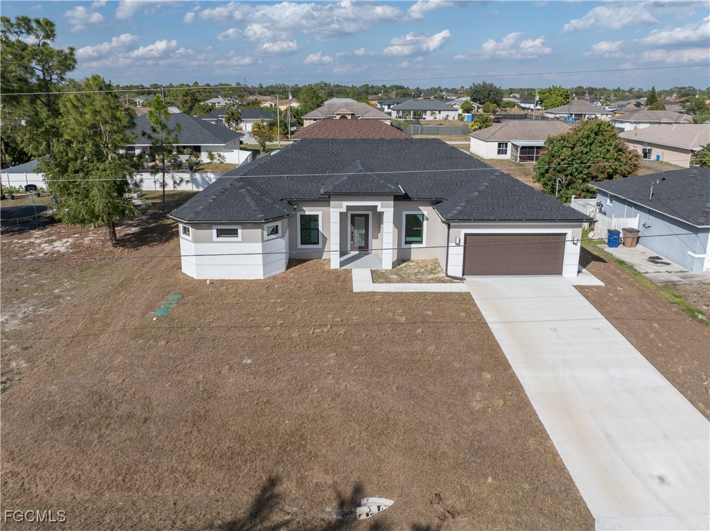 3728 9th Street West Lehigh Acres, FL 33971 - Photo 3 of 35 front view of a house with a yard