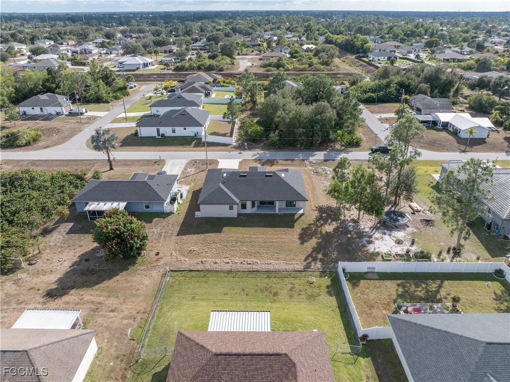 3728 9th Street West Lehigh Acres, FL 33971 - Photo 32 of 35 an aerial view of a house with a yard