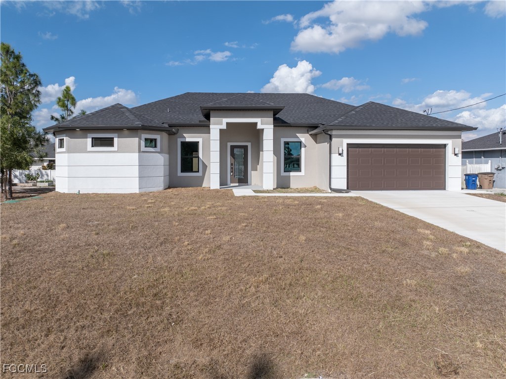 3728 9th Street West Lehigh Acres, FL 33971 - Photo 34 of 35 a front view of a house with a yard and garage
