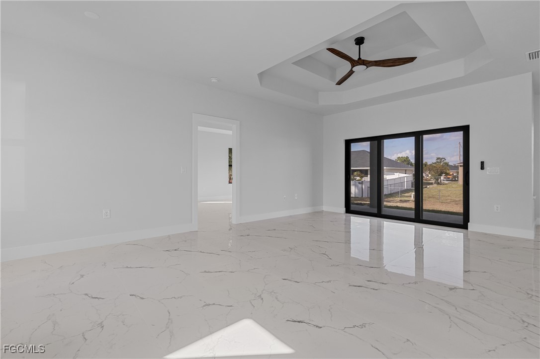 3728 9th Street West Lehigh Acres, FL 33971 - Photo 5 of 35 wooden floor in an empty room with a window