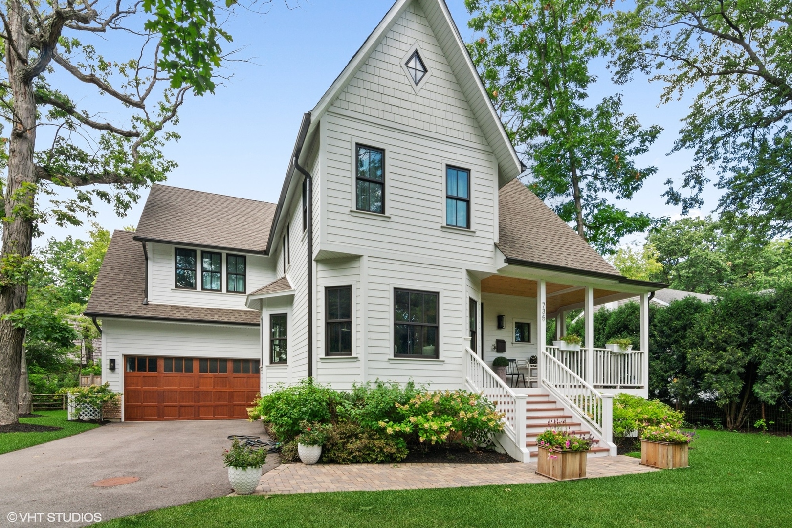 a front view of a house with garden and porch