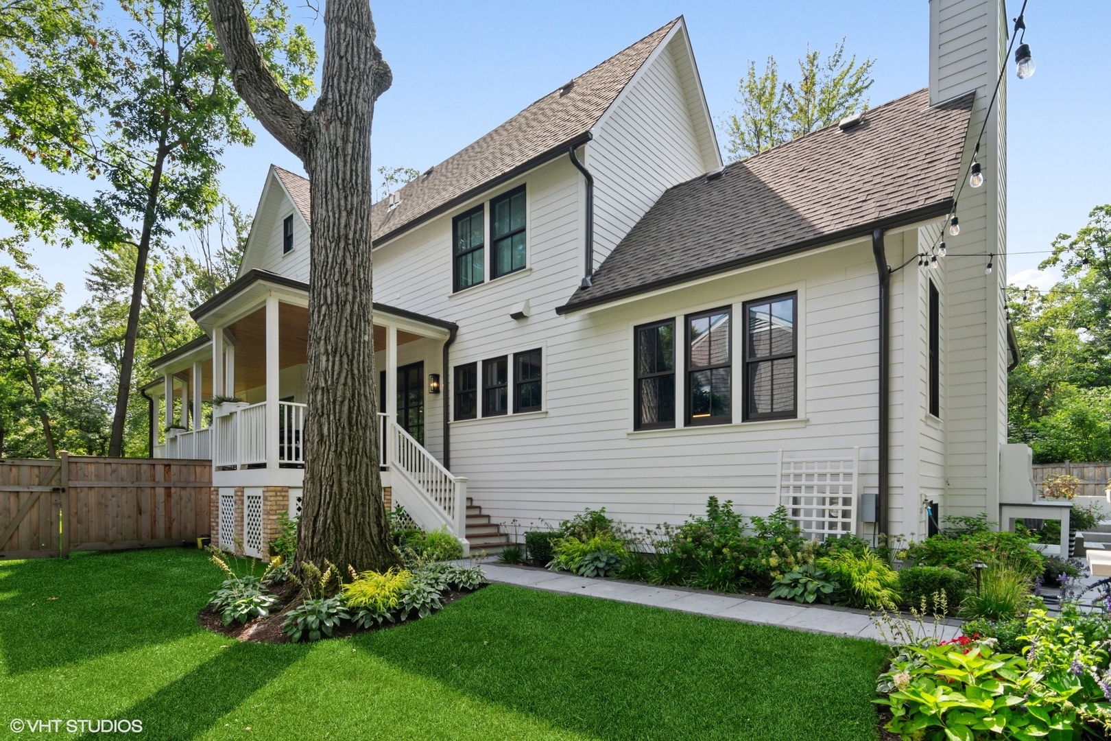 735 Baldwin Road Highland Park, IL 60035 - Photo 23 of 30 a view of a house with brick walls and a yard with a large tree