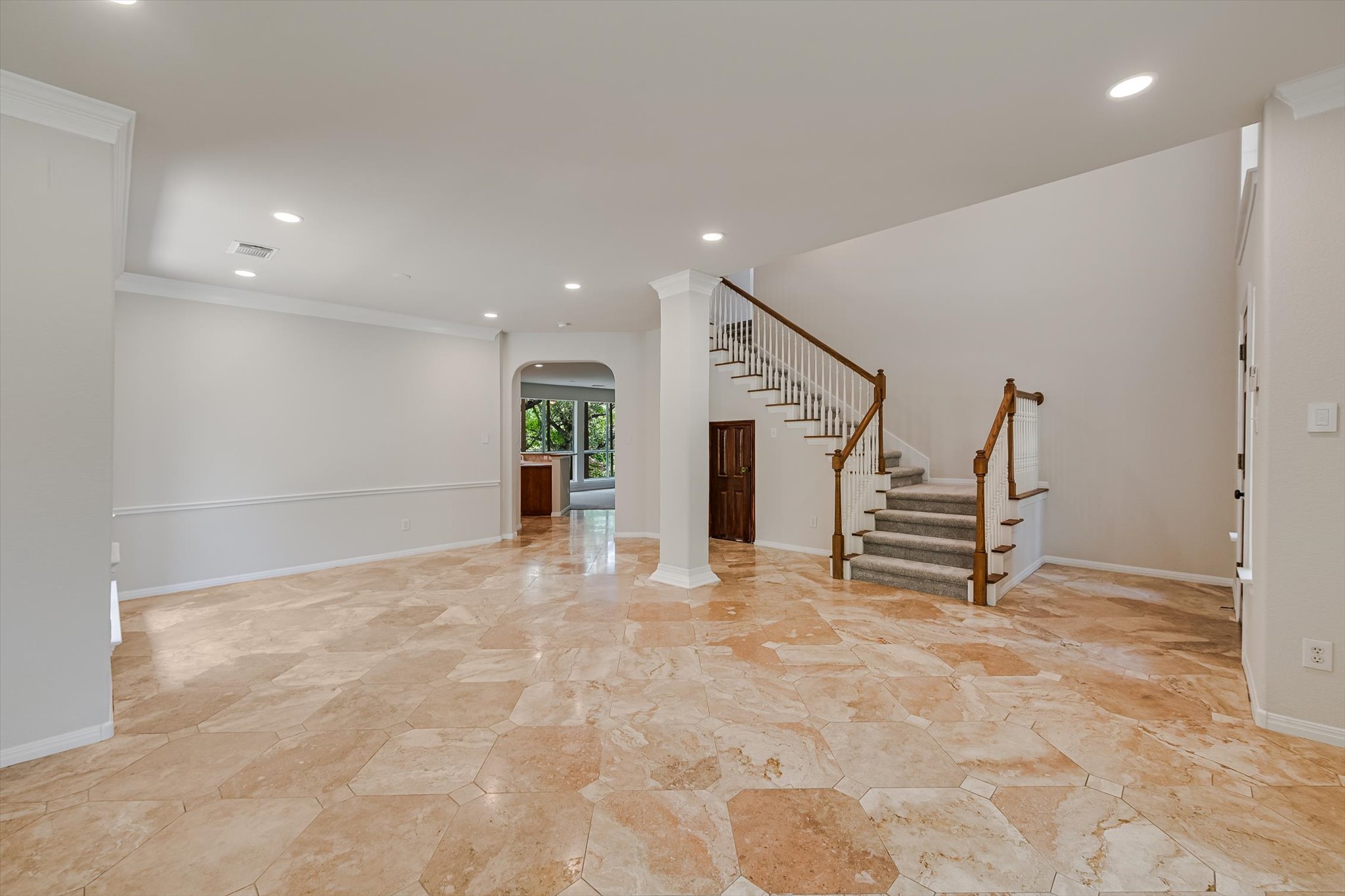 2849 Grimes Ranch Road Austin, TX 78732 - Photo 5 of 31 A grand staircase and natural stone flooring define this welcoming entry.