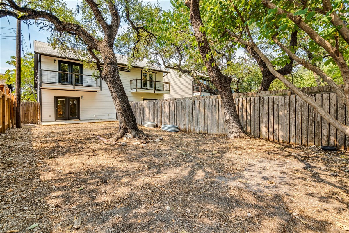 2811 Hardeman Street, Unit B Austin, TX 78704 - Photo 26 of 34 Mature shade trees and a sturdy wood fence frame this private backyard setting.