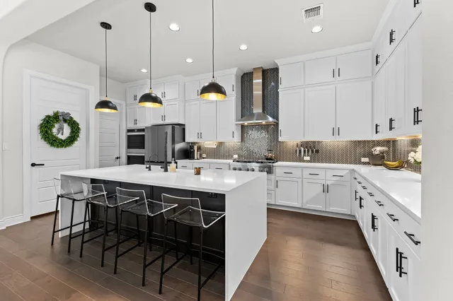 a kitchen with stainless steel appliances kitchen island granite countertop a sink and cabinets