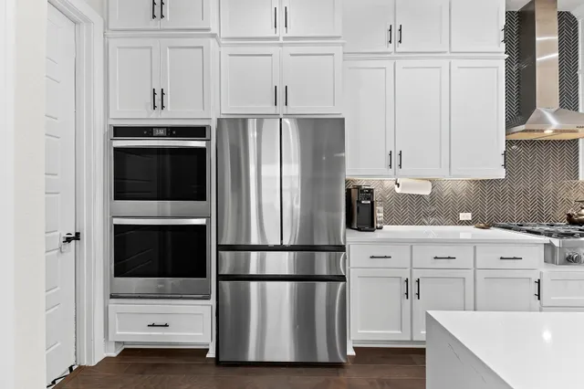 a kitchen with cabinets and stainless steel appliances