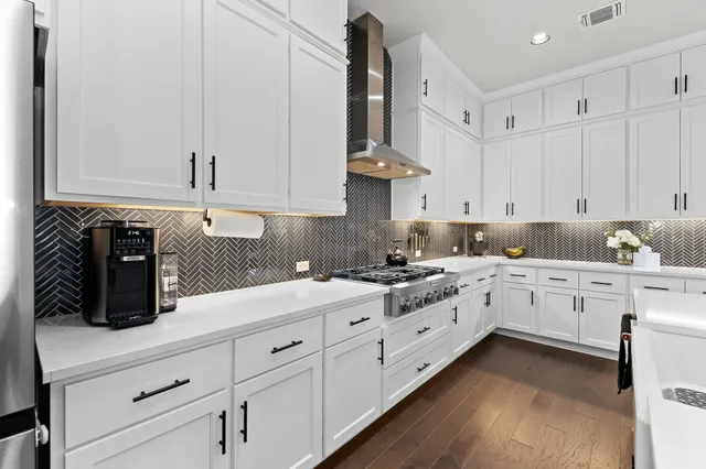 a kitchen with granite countertop white cabinets and white appliances