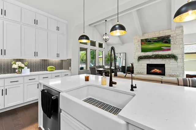 a kitchen with a sink a stove and cabinets
