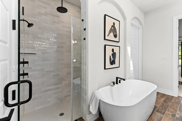 a bathroom with a bathtub and shower