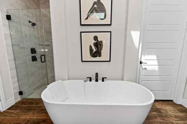 a white tub sitting next to a bathroom