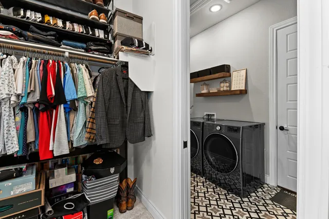 a view of walk in closet with clothes and shoes