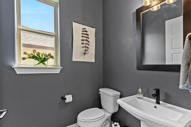 a white toilet sitting next to a bathroom sink