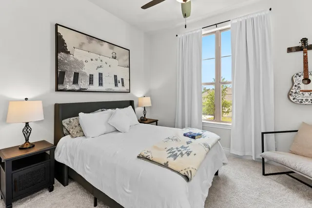 a bedroom with a large bed and a window