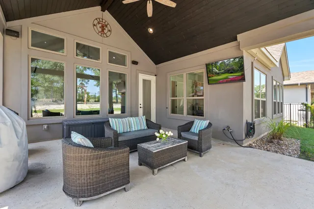 a living room with furniture and a floor to ceiling window