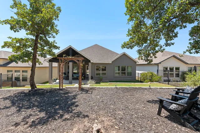 a view of a house with swimming pool and sitting area