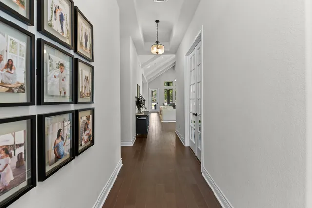 a view of a hallway with paintings on the wall