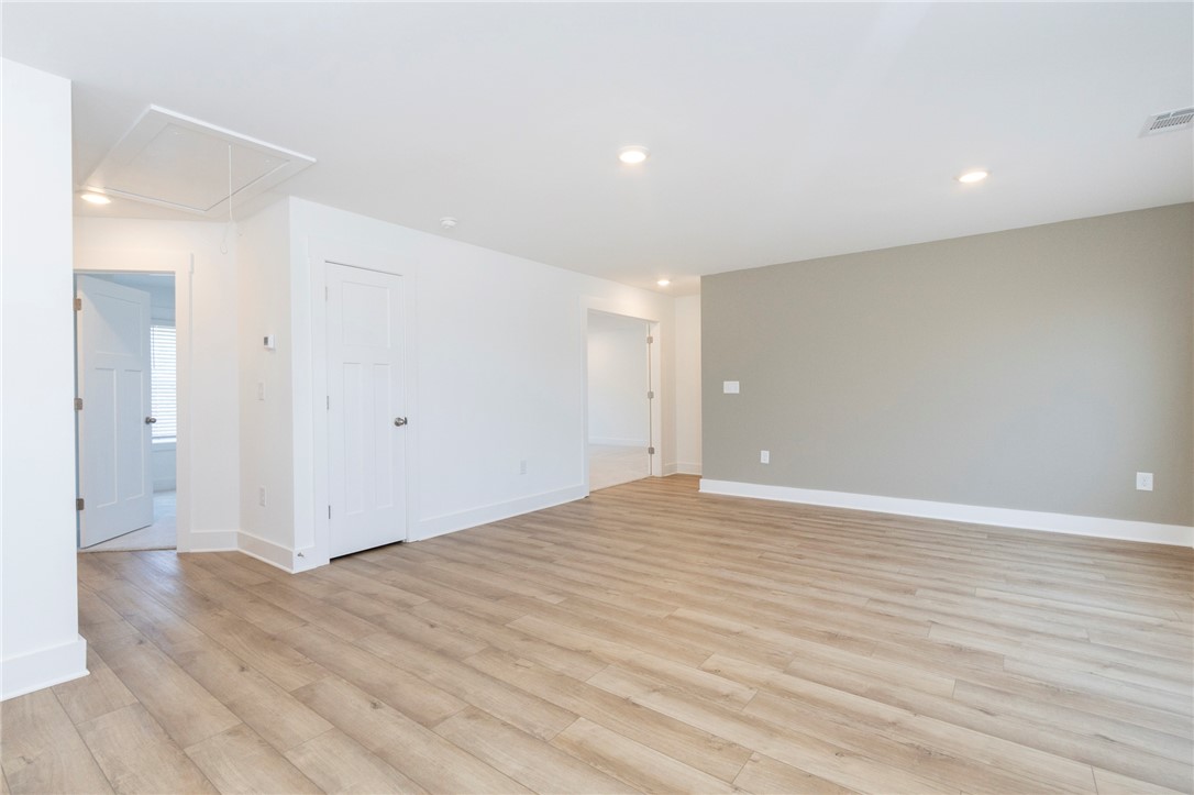 607 WH Kay Lane Anderson, SC 29621 - Photo 20 of 48 Warm wood-look flooring extends throughout this versatile, well-lit bonus room, offering boundless possibilities.